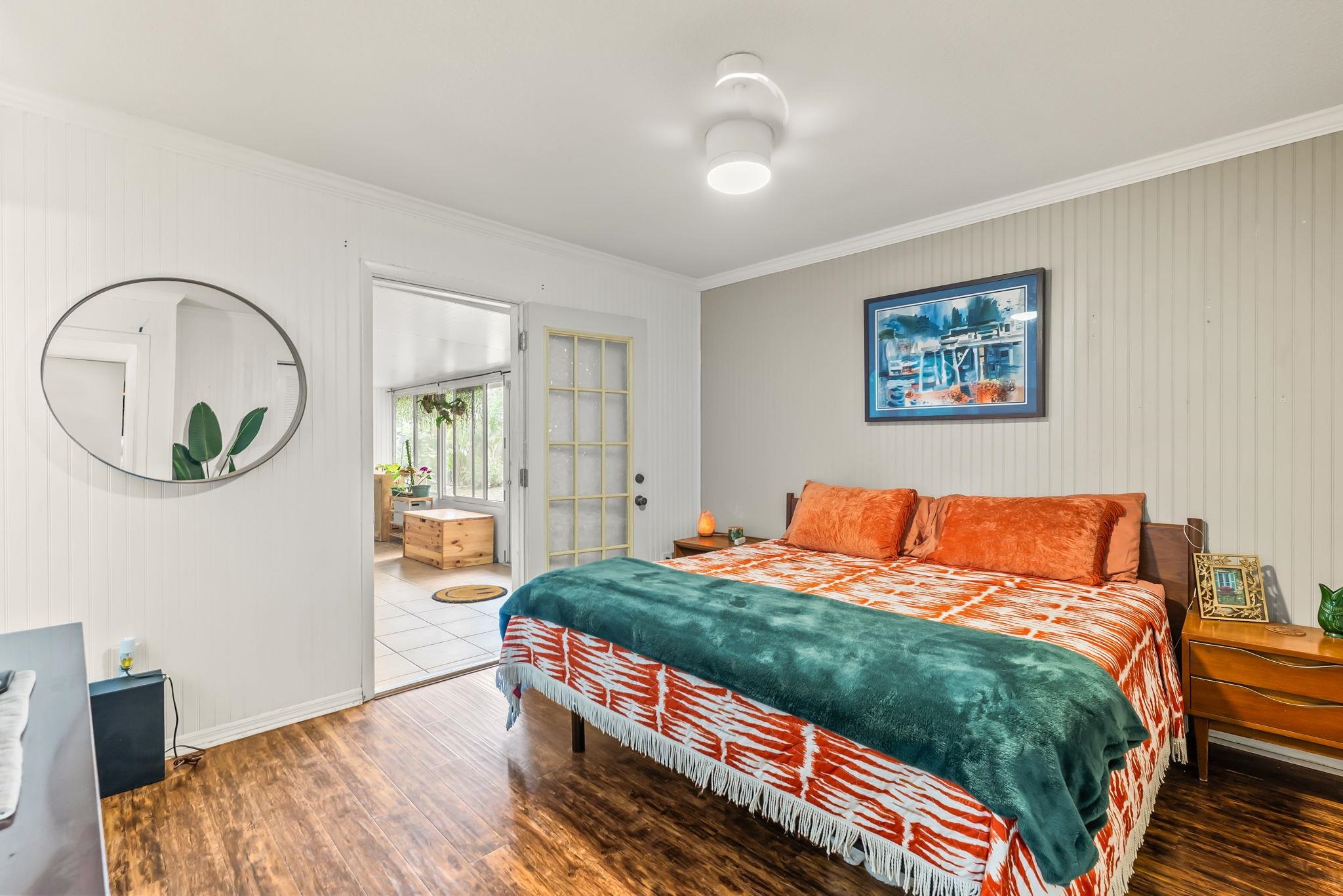 129 Pelican Road St. Augustine, FL 32086 - Photo 3 of 34 Bedroom featuring wood finished floors, ornamental molding, and wood walls