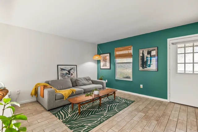 a kitchen with a sink stainless steel appliances cabinets and a window