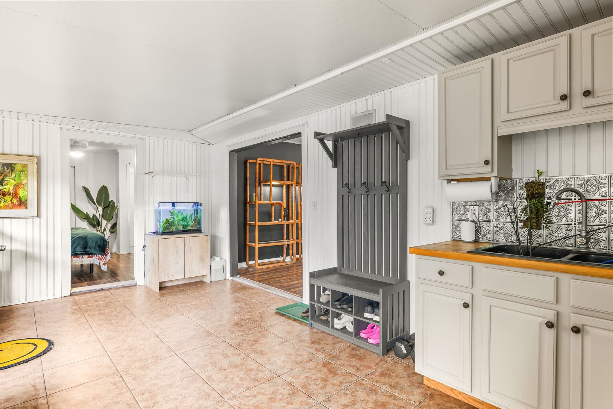 129 Pelican Road St. Augustine, FL 32086 - Photo 7 of 34 Mudroom with light tile patterned floors and wood walls