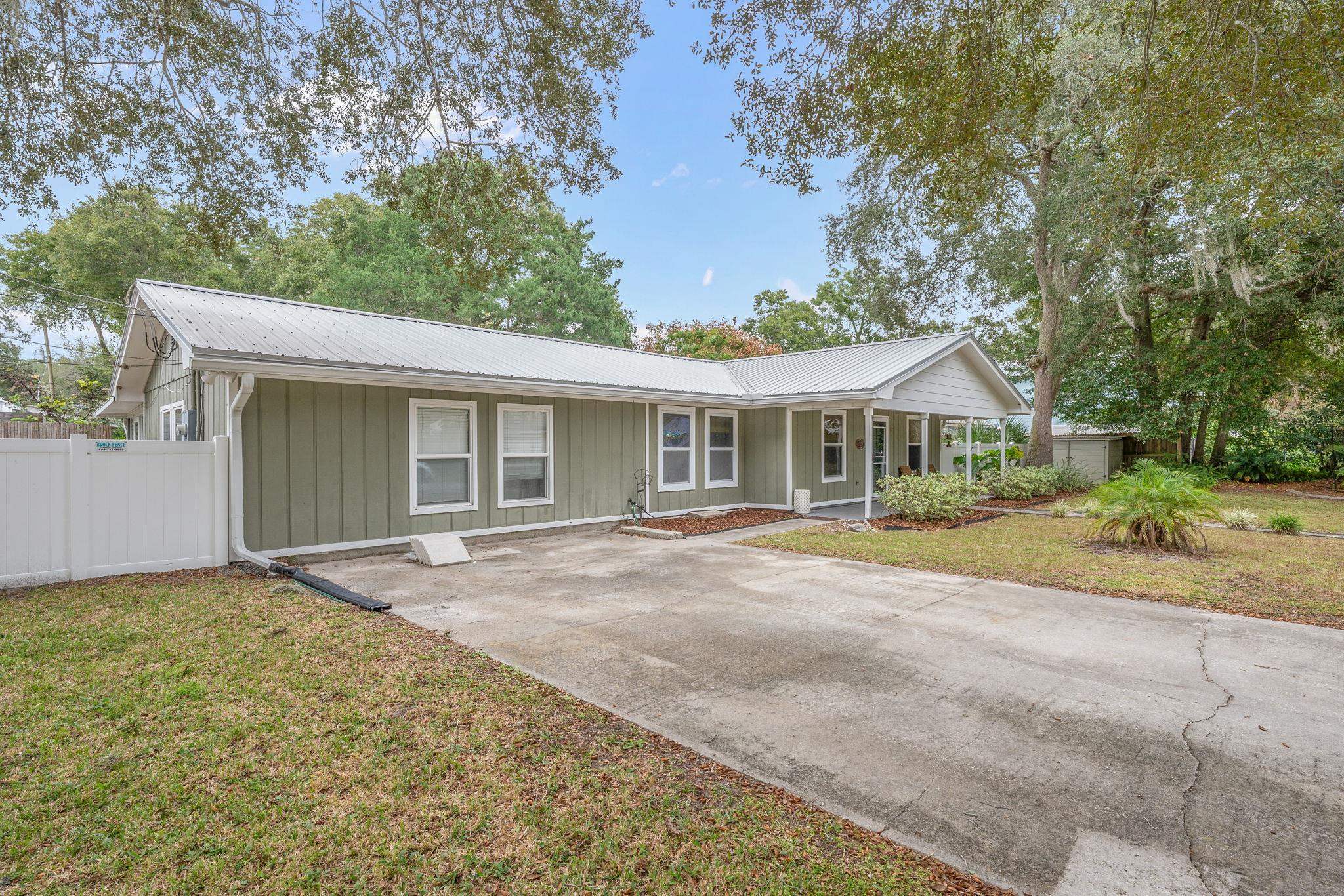 129 Pelican Road St. Augustine, FL 32086 - Photo 8 of 34 Ranch-style house with covered porch, a metal roof, and concrete driveway