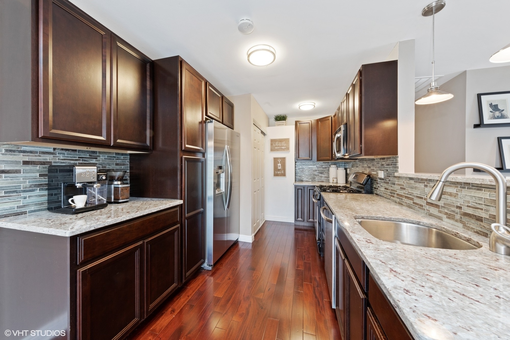 1675 Valley Forge Court, Unit A Wheaton, IL 60189 - Photo 4 of 11 a kitchen with granite countertop stainless steel appliances cabinets a sink and a counter space