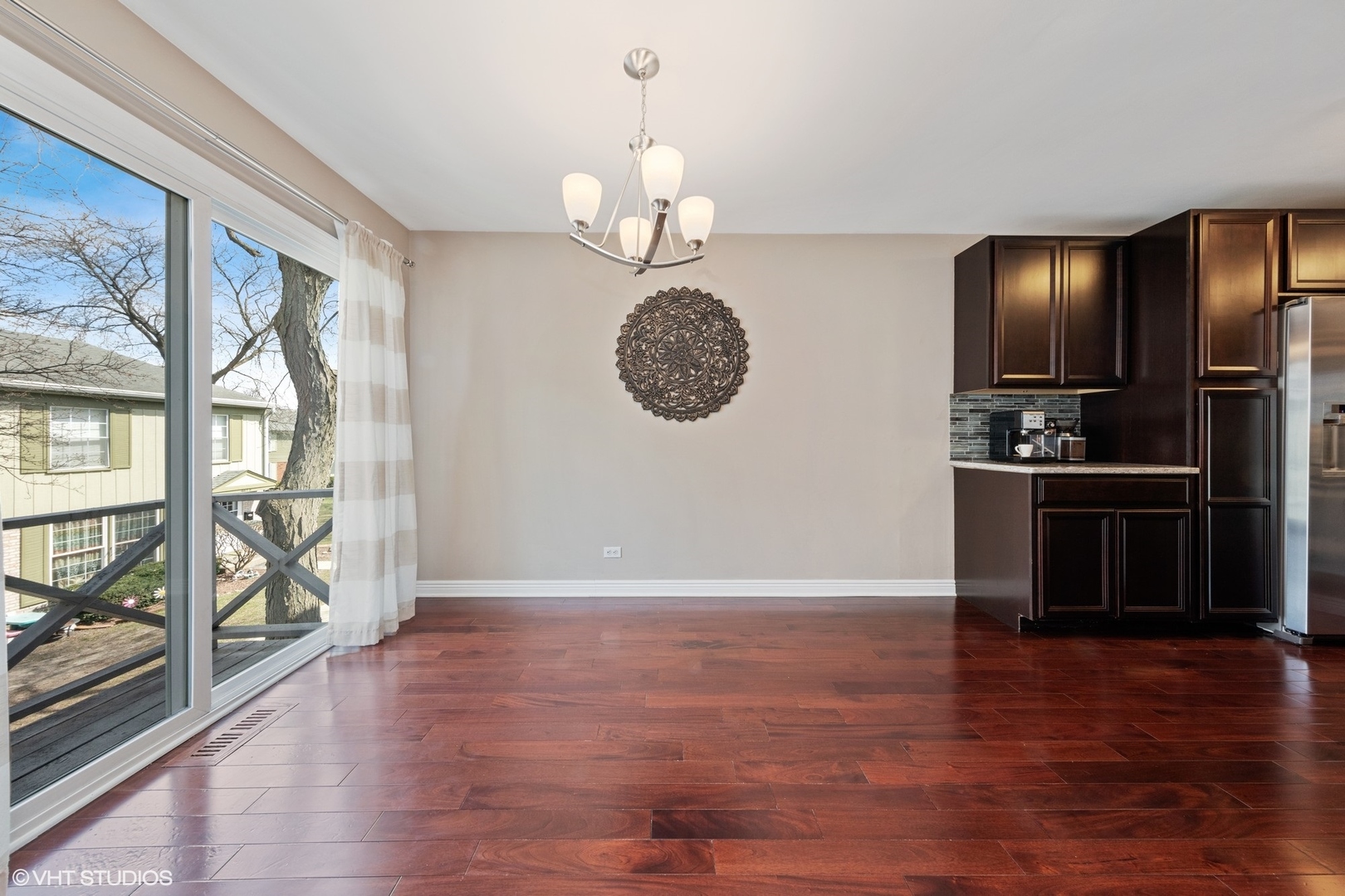 1675 Valley Forge Court, Unit A Wheaton, IL 60189 - Photo 6 of 11 an empty room with wooden floor and windows