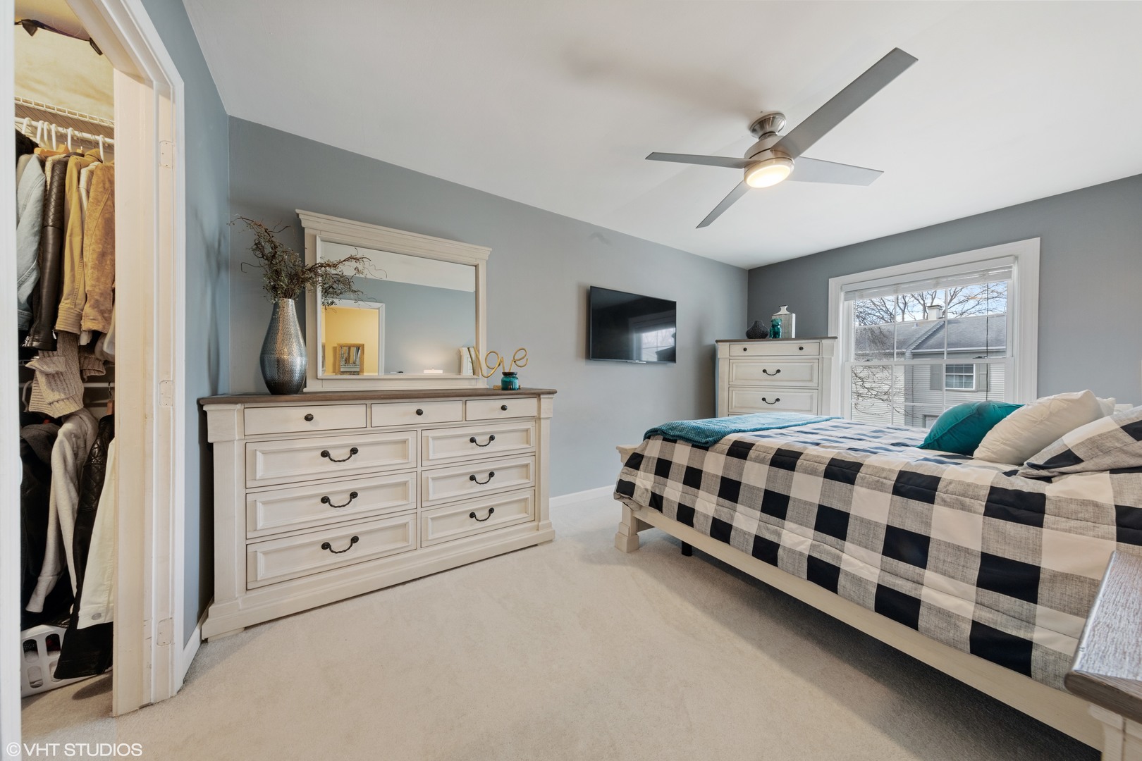 1675 Valley Forge Court, Unit A Wheaton, IL 60189 - Photo 10 of 11 a bedroom with a bed a mirror on dresser and a window