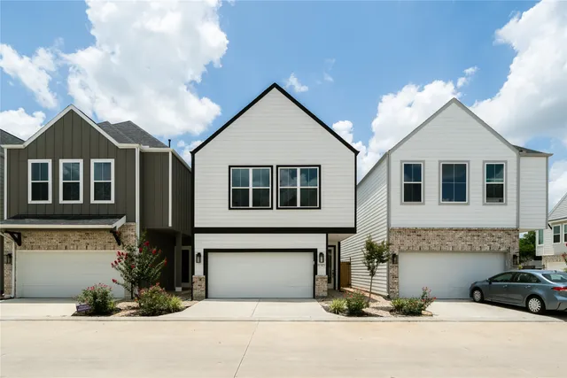 a view of a house with a yard and garage
