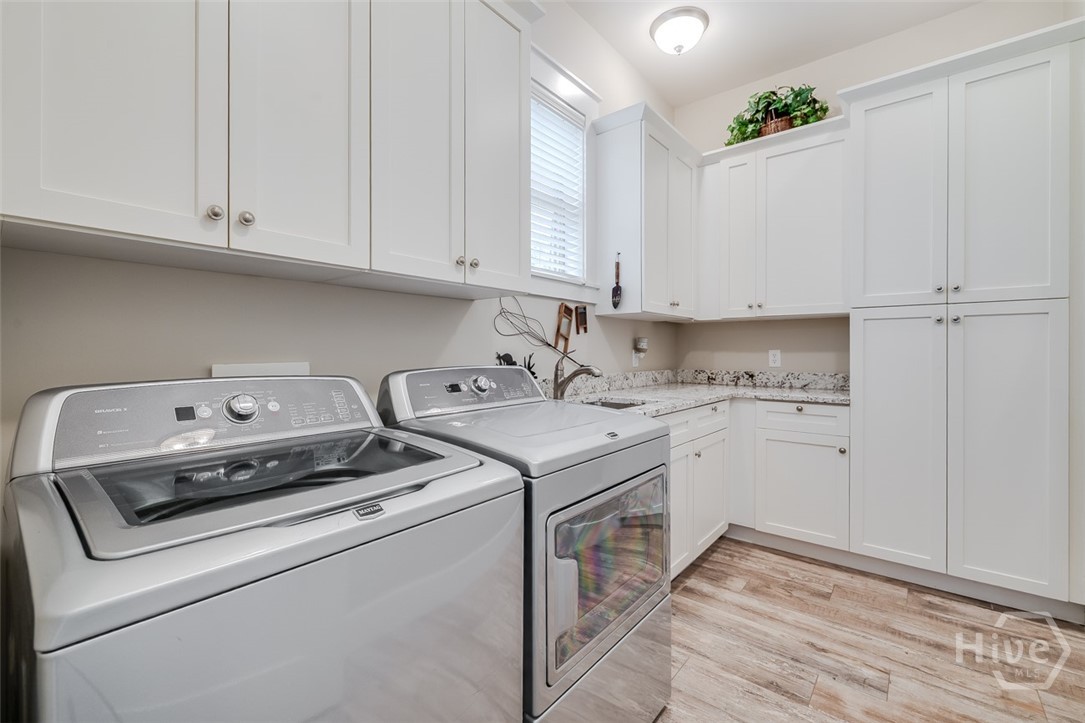 36 Oldfield Village Road Bluffton, SC 29909 - Photo 18 of 64 Laundry room with more cabinetry and sink