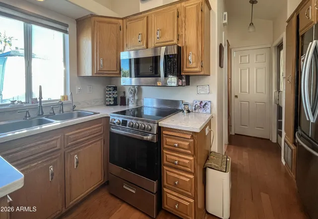 a kitchen with stainless steel appliances granite countertop a sink stove and microwave