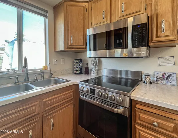 a metallic refrigerator freezer sitting in a kitchen