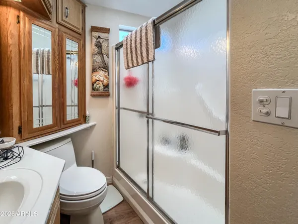 a bedroom with a bed and a large mirror on the dresser