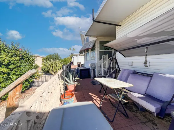a view of a house with a yard table and chairs