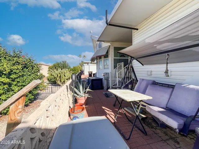 a view of a house with a yard table and chairs