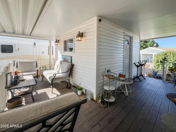 a view of a balcony with chairs and a potted plant