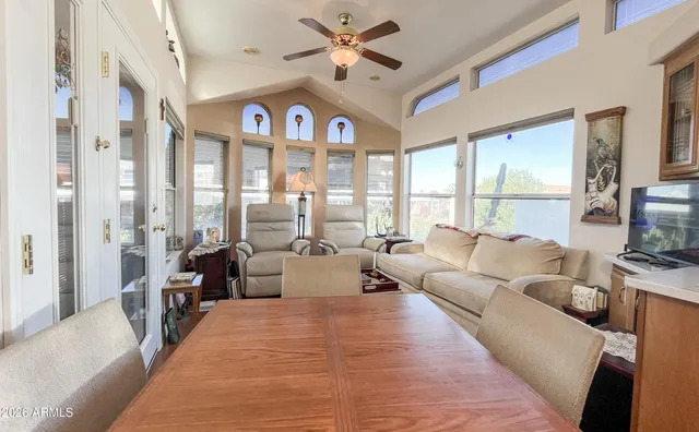 a view of a a dining room with furniture window and wooden floor