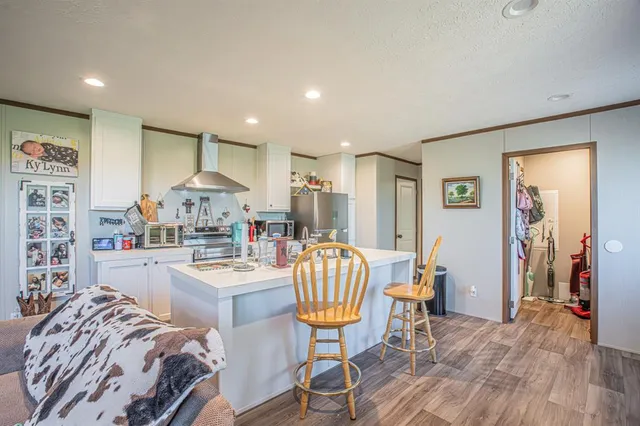 a kitchen with stainless steel appliances granite countertop a sink and a refrigerator