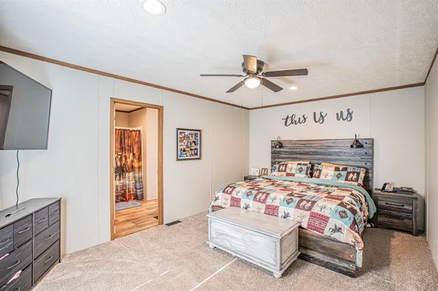 a bedroom with a bed and a chandelier