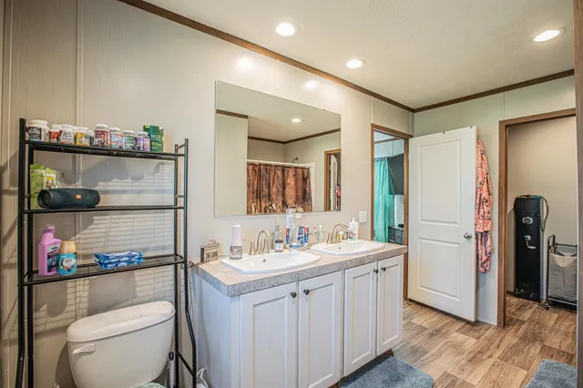 a bathroom with a toilet sink and mirror