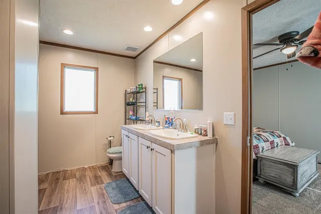 a bathroom with a sink a toilet and a mirror