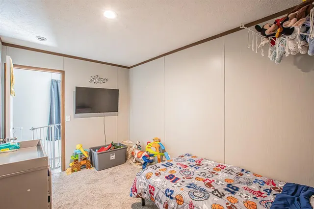 a bedroom with a bed and a tv