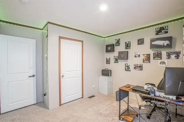 a view of a workspace with furniture and a window