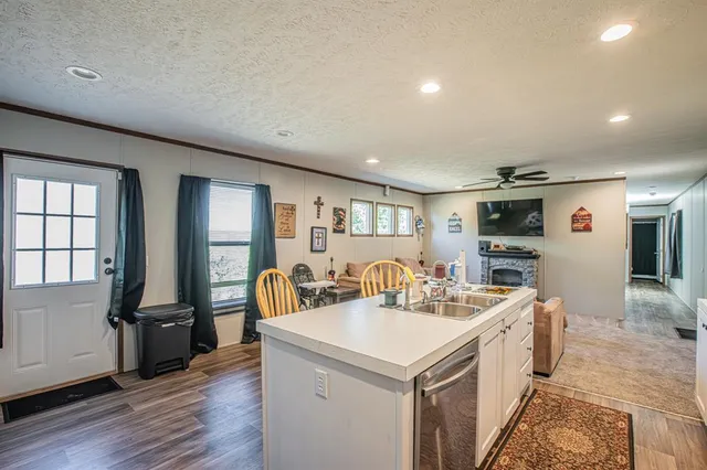 a view of a kitchen area with furniture and wooden floor