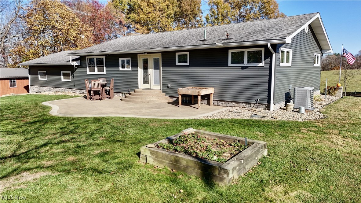 15235 Stocker Ridge Road Southwest Newcomerstown, OH 43832 - Photo 10 of 37 Back of house with a patio area, a lawn, and central AC unit
