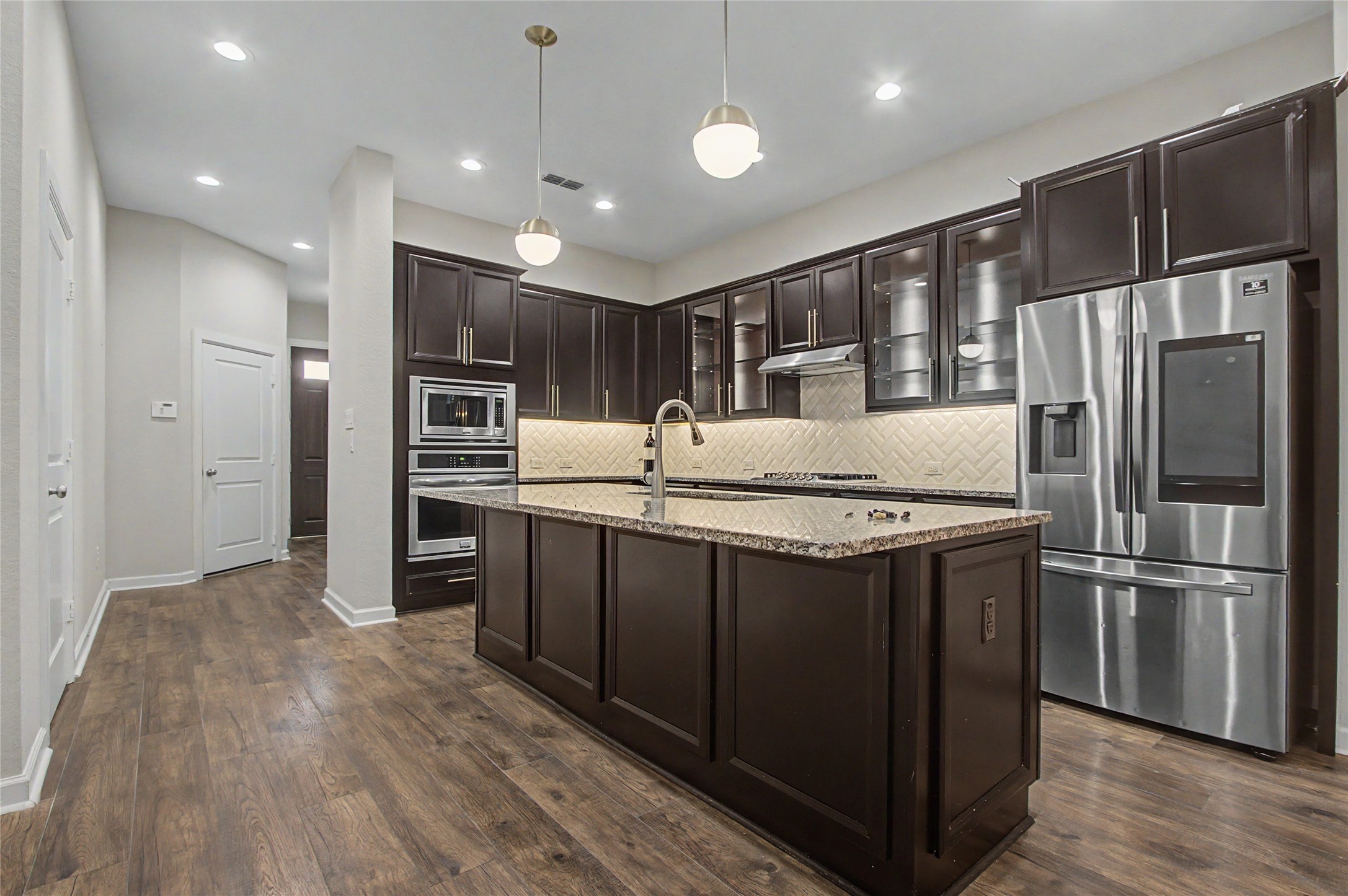 19718 Shinnery Ridge Court Cypress, TX 77433 - Photo 4 of 23 a kitchen with stainless steel appliances granite countertop a refrigerator a sink and a stove