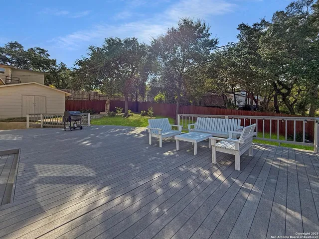a view of a patio with a table and chairs