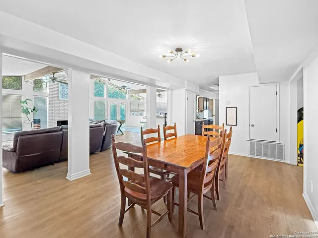 a view of a dining room with furniture and wooden floor