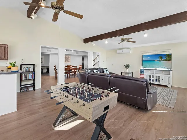 a living room with furniture and kitchen view