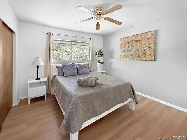 a bed sitting in a bedroom next to a window