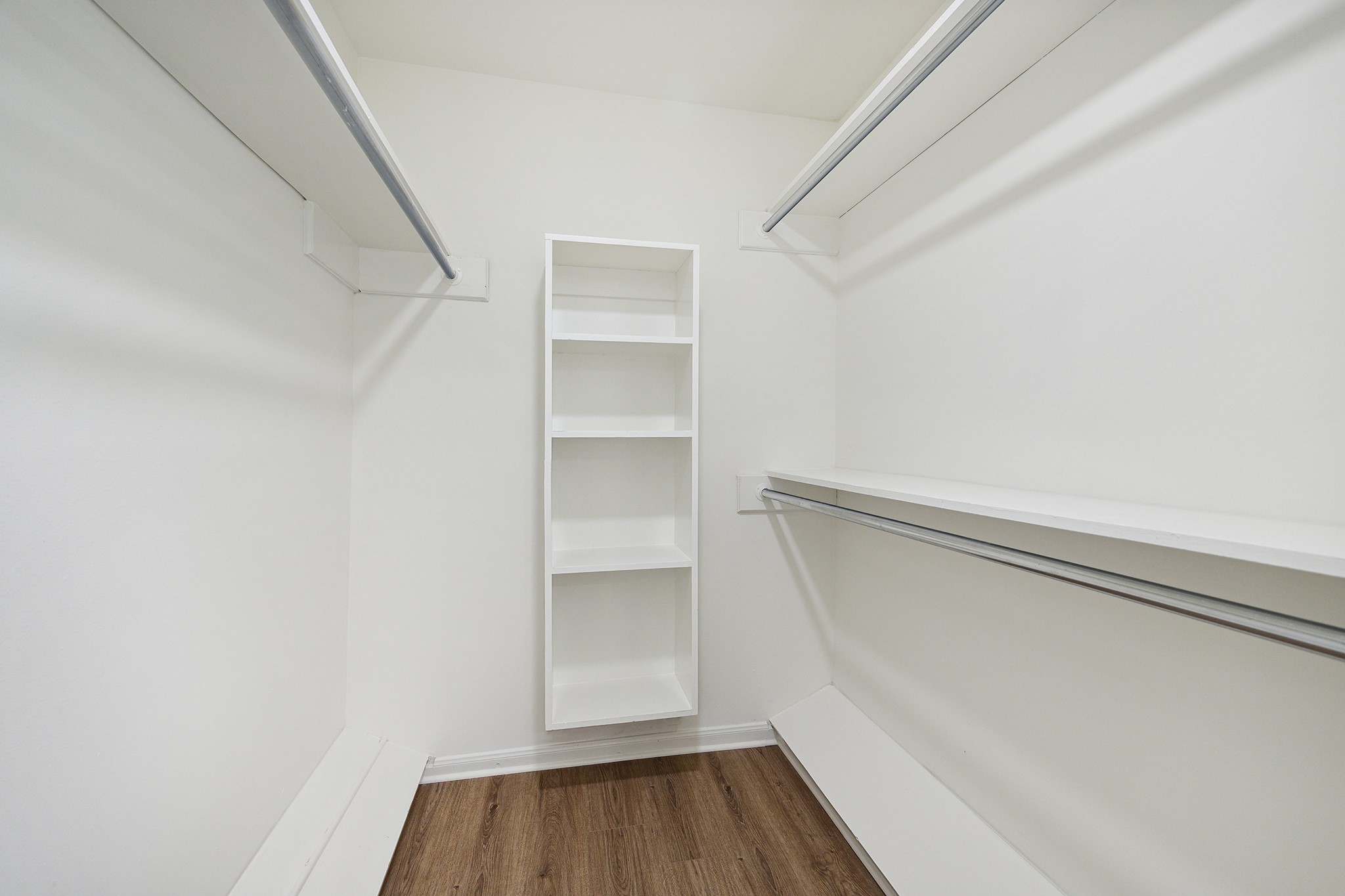9719 Springmont Drive Houston, TX 77080 - Photo 24 of 32 Master closet is spacious with multiple rows for clothing hanging and custom built-in shelving!
