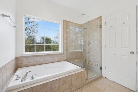 an empty room with chandelier fan