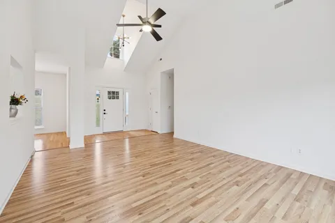a view of empty room with wooden floor