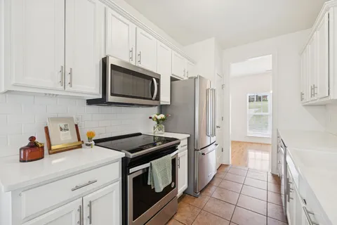 a kitchen with stainless steel appliances a stove a microwave and a refrigerator