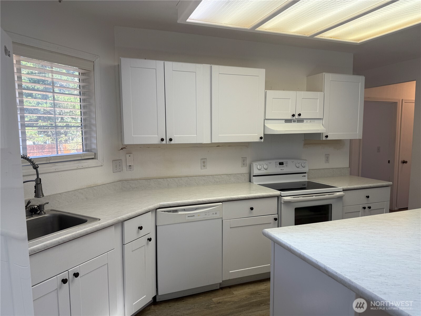 13208 Pacific Way Long Beach, WA 98631 - Photo 15 of 40 a kitchen with cabinets appliances a sink and a window