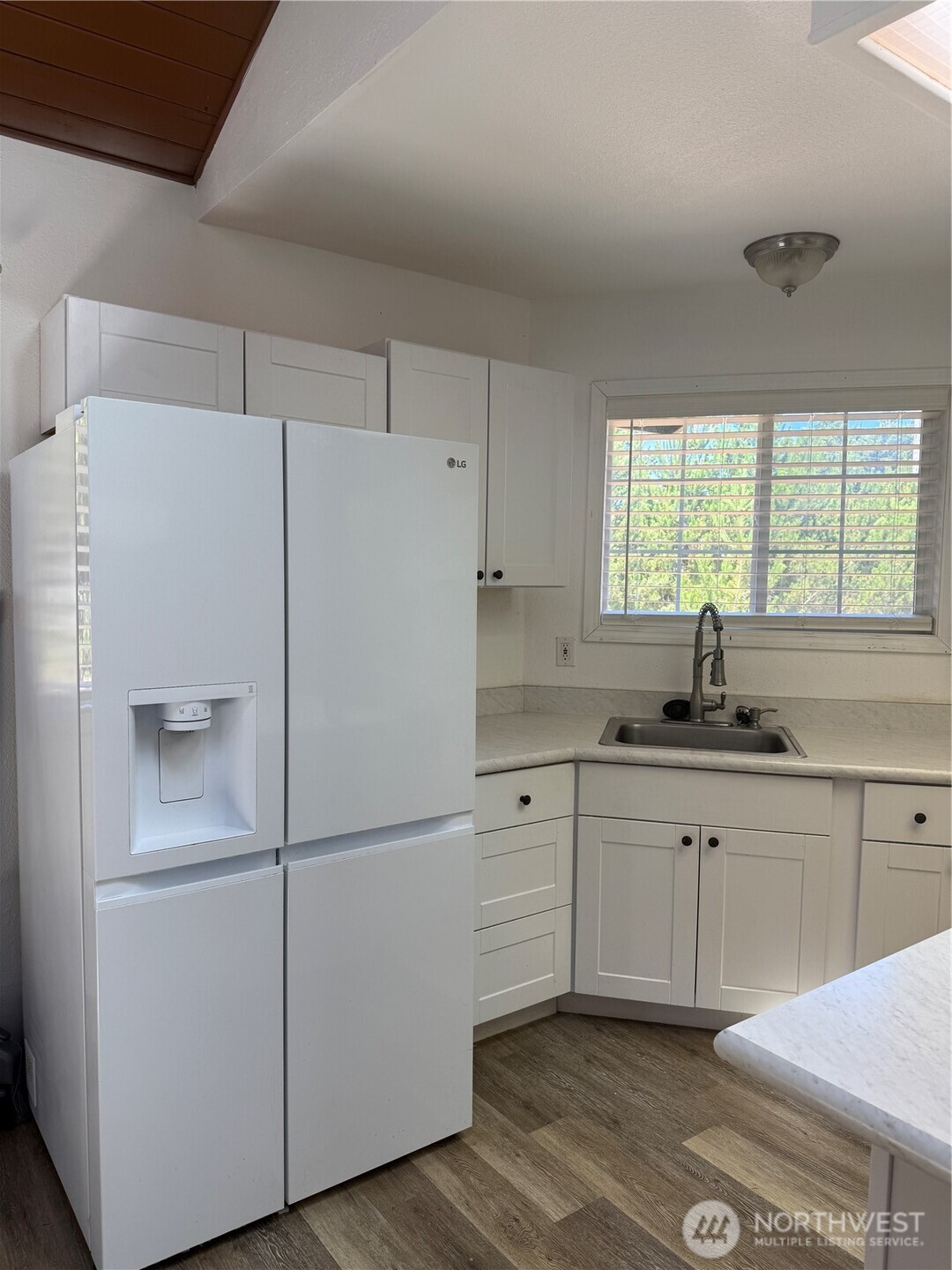13208 Pacific Way Long Beach, WA 98631 - Photo 17 of 40 a white refrigerator freezer sitting in a kitchen