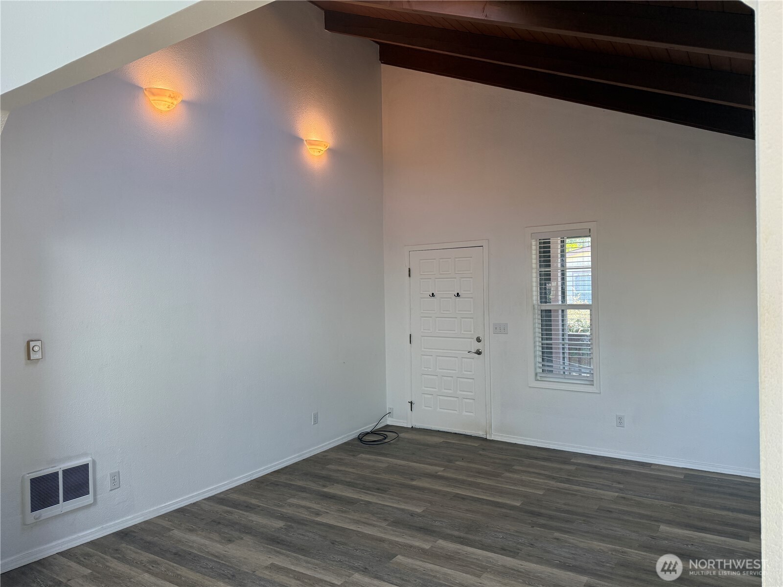 13208 Pacific Way Long Beach, WA 98631 - Photo 10 of 40 an empty room with wooden floor and windows