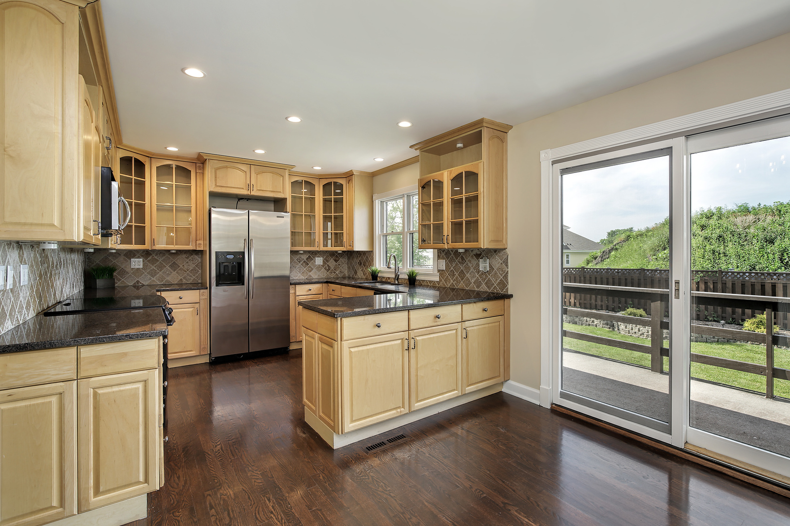 919 Suffield Terrace Northbrook, IL 60062 - Photo 2 of 13 a kitchen with stainless steel appliances granite countertop a refrigerator a stove a sink and white cabinets with wooden floor