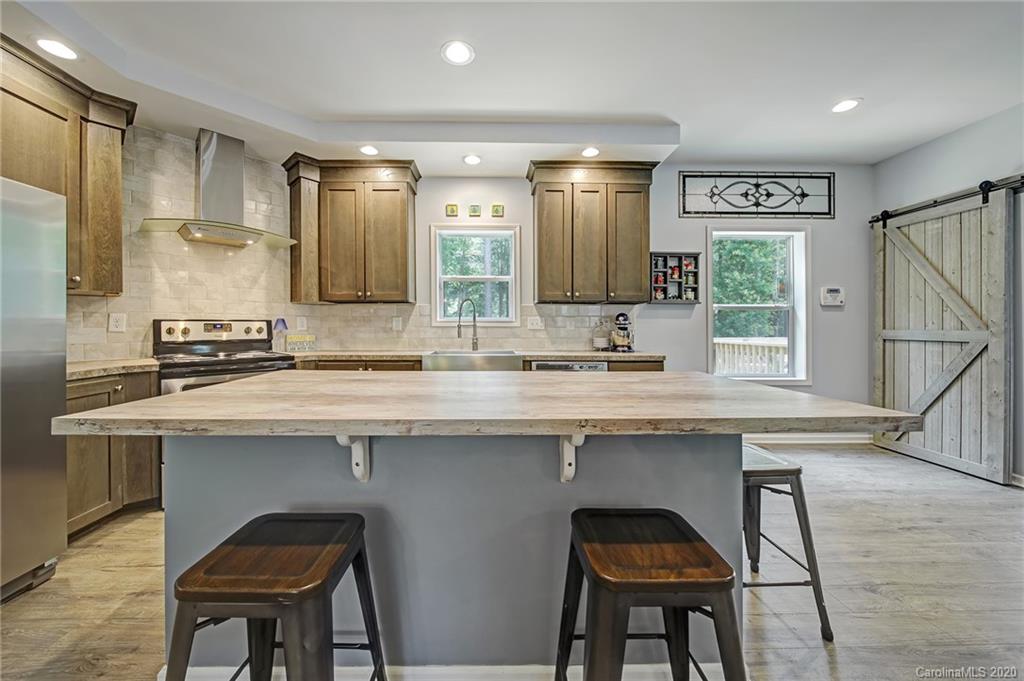 2041 Haire Road Fort Mill, SC 29715 - Photo 14 of 44 a kitchen with stainless steel appliances granite countertop white cabinets and chairs