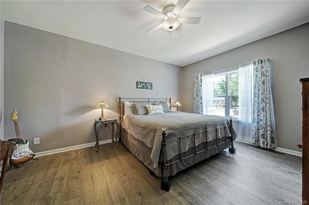 2041 Haire Road Fort Mill, SC 29715 - Photo 22 of 44 a bedroom with a bed and a chandelier