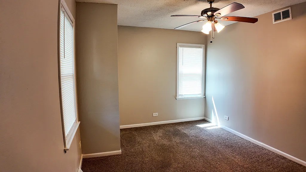 11604 South Kenneth Avenue Alsip, IL 60803 - Photo 5 of 26 an empty room with windows and fan