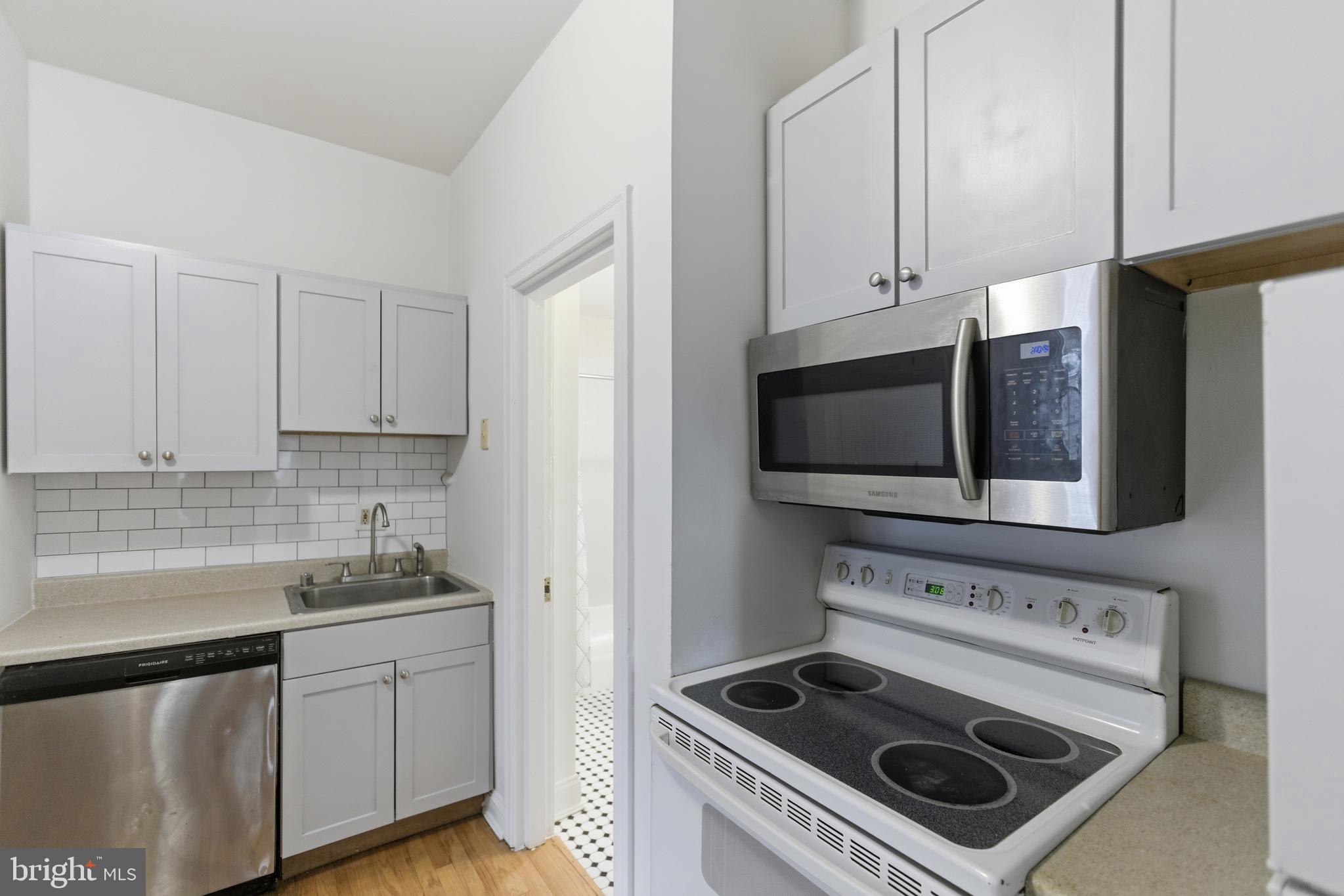 1226 F Street Northeast, Unit 3 Washington, DC 20002 - Photo 11 of 15 a kitchen with a stove and a microwave