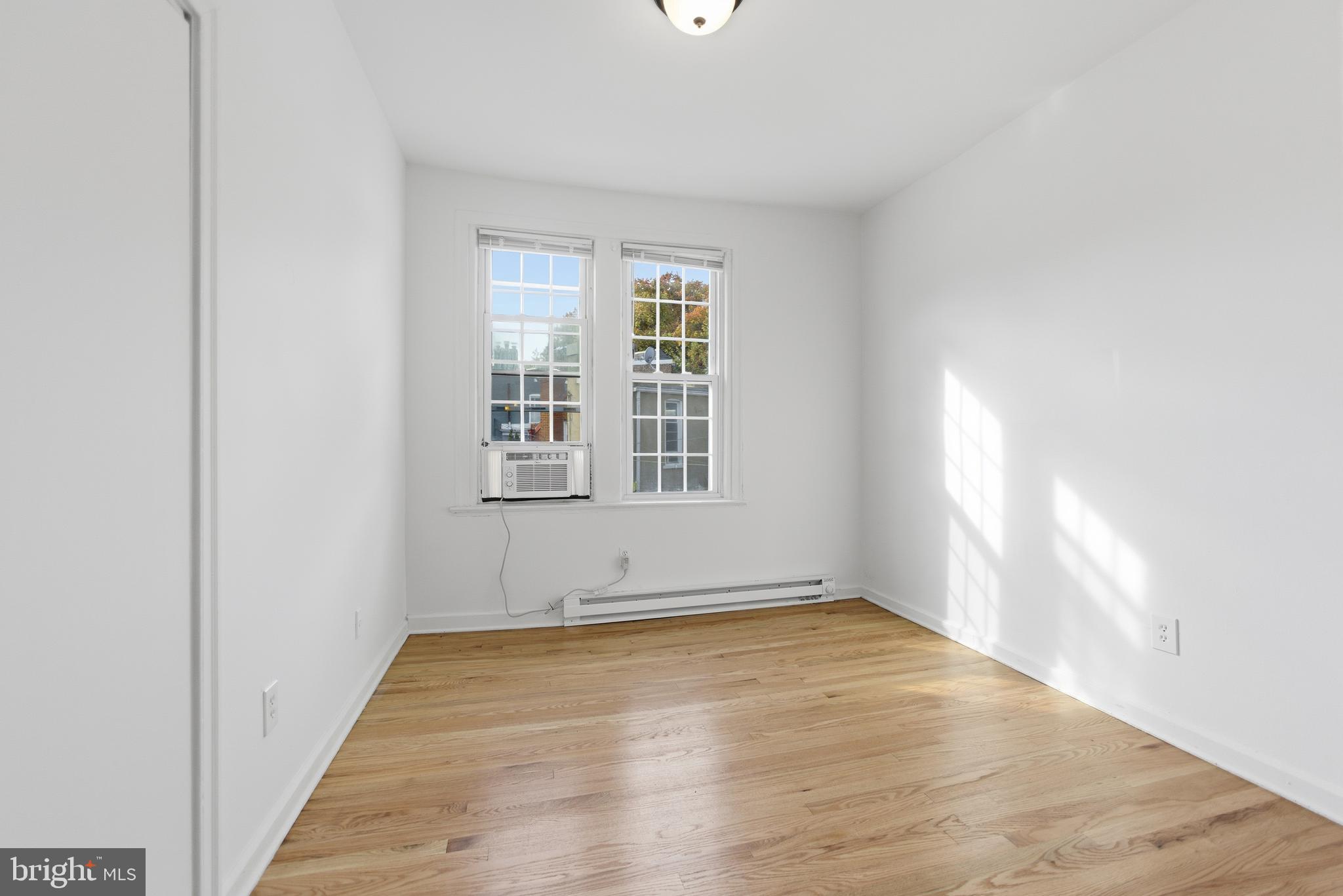 1226 F Street Northeast, Unit 3 Washington, DC 20002 - Photo 3 of 15 an empty room with wooden floor and windows