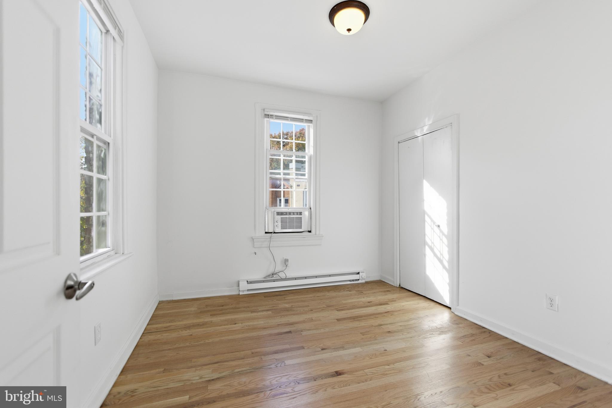 1226 F Street Northeast, Unit 3 Washington, DC 20002 - Photo 6 of 15 an empty room with wooden floor and windows