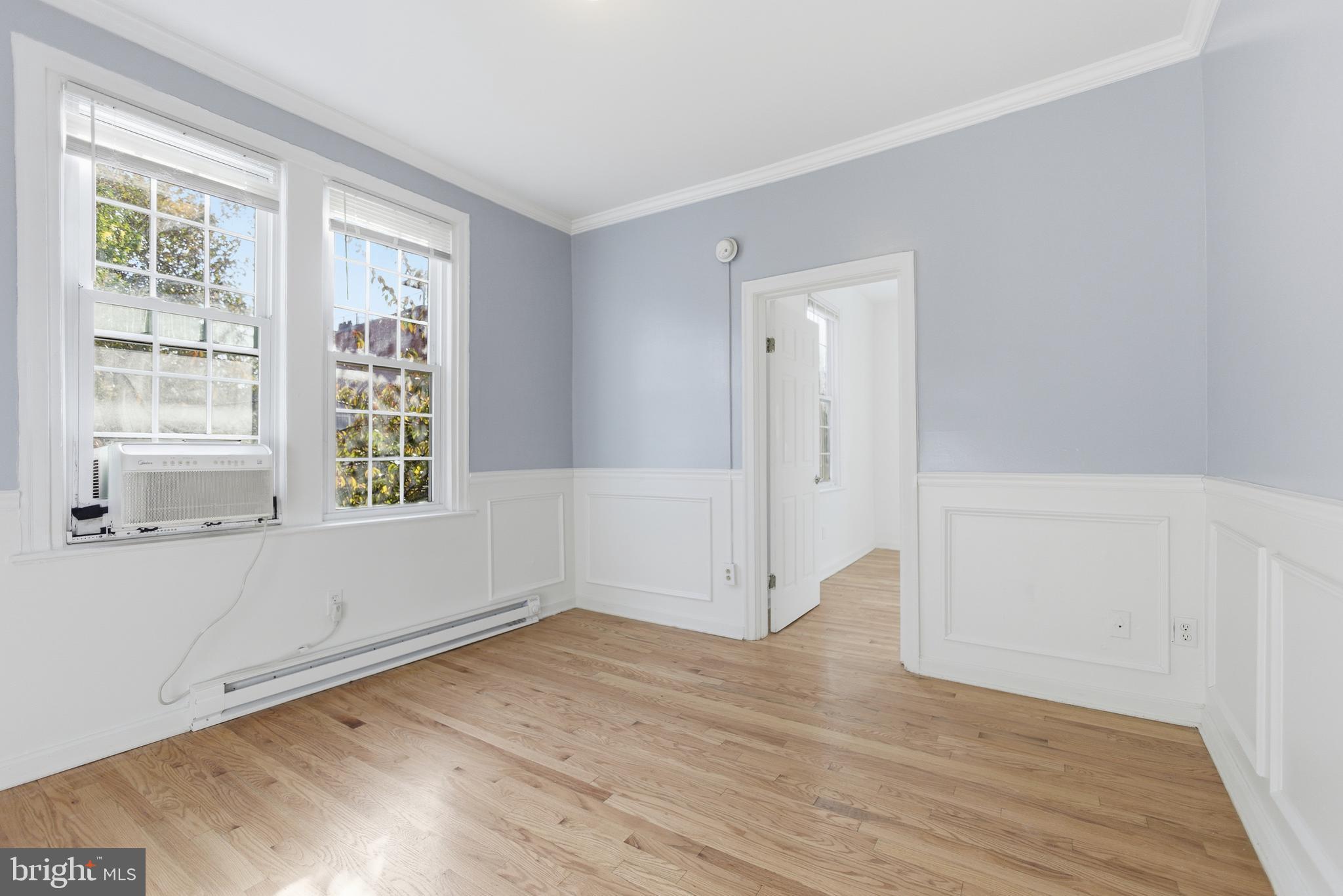 1226 F Street Northeast, Unit 3 Washington, DC 20002 - Photo 8 of 15 an empty room with wooden floor and windows