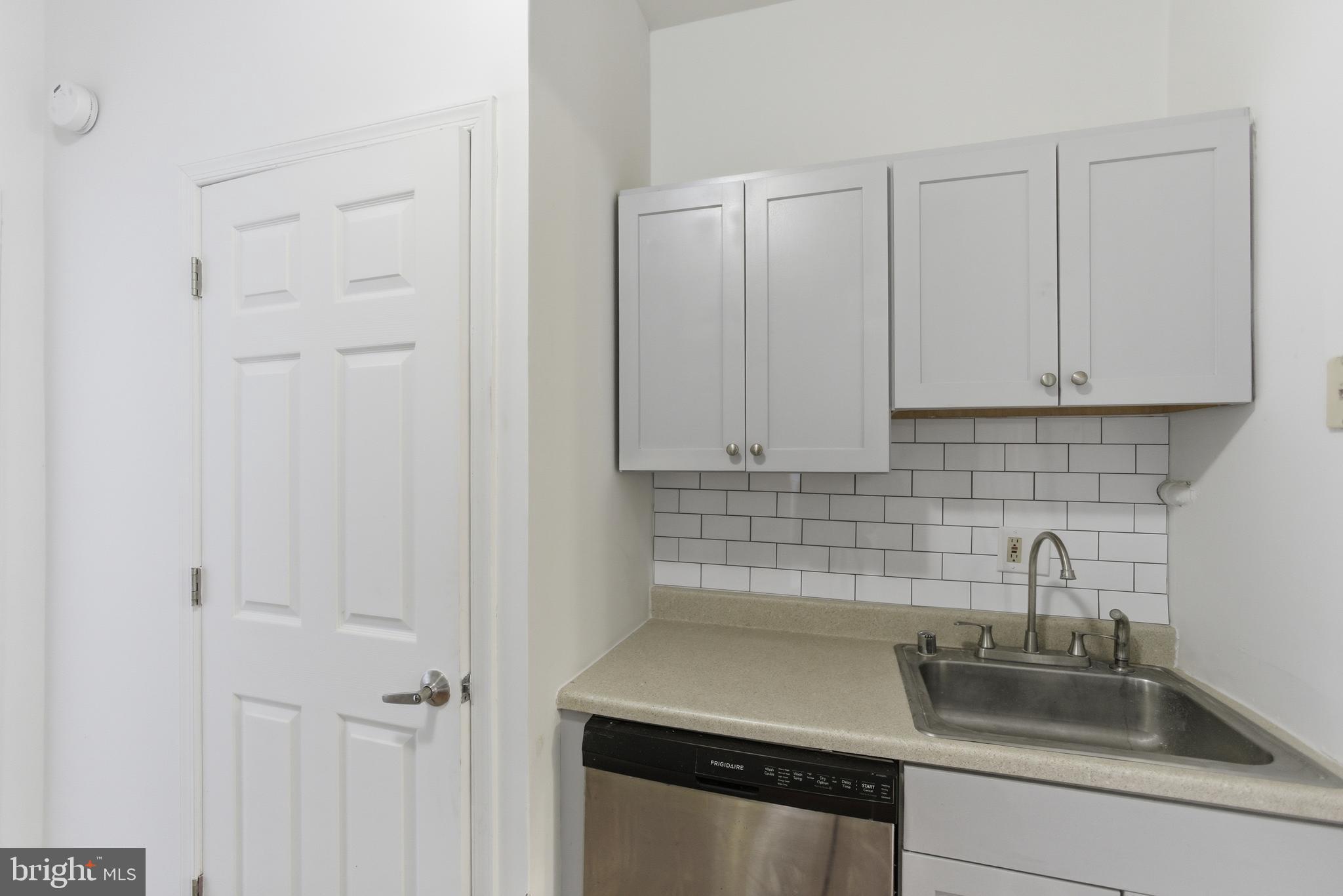 1226 F Street Northeast, Unit 3 Washington, DC 20002 - Photo 10 of 15 a kitchen with a sink and cabinets