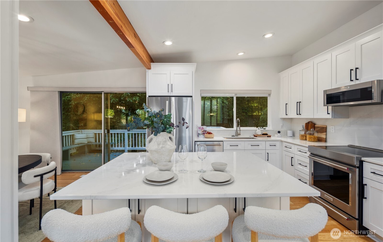 201 165th Avenue Northeast Bellevue, WA 98008 - Photo 6 of 13 a kitchen with a table chairs and white cabinets