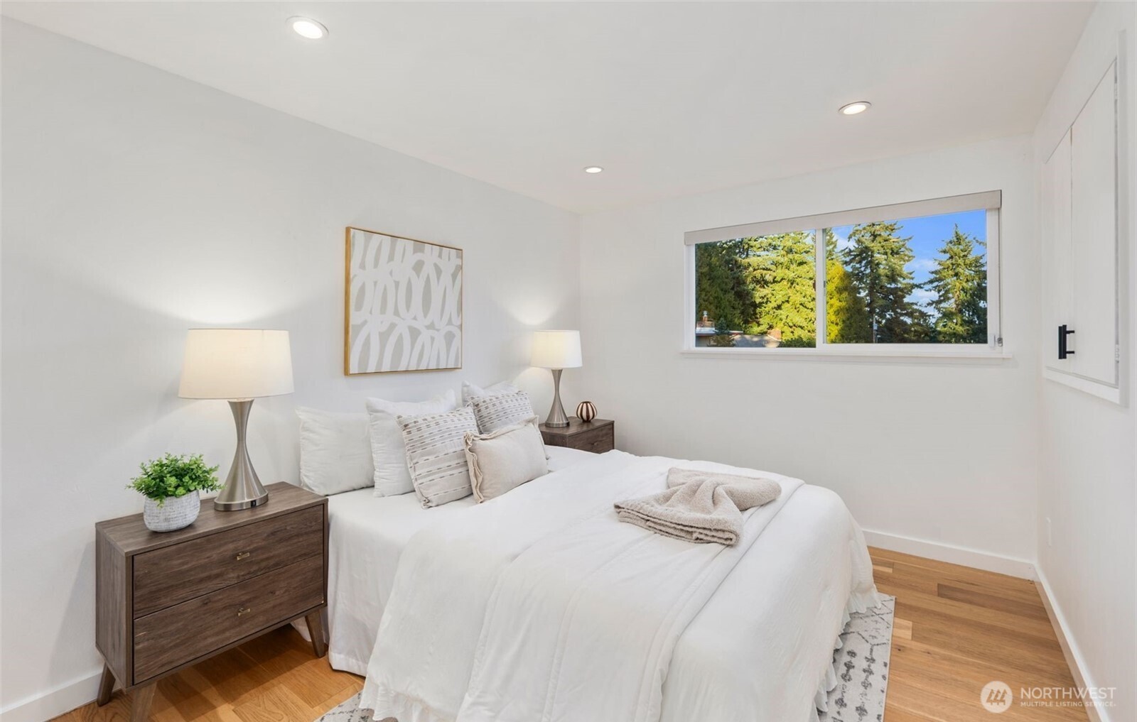201 165th Avenue Northeast Bellevue, WA 98008 - Photo 10 of 13 a bedroom with bed and painting on the wall