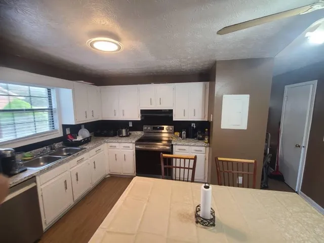 a kitchen with stainless steel appliances granite countertop a stove a sink dishwasher and a refrigerator