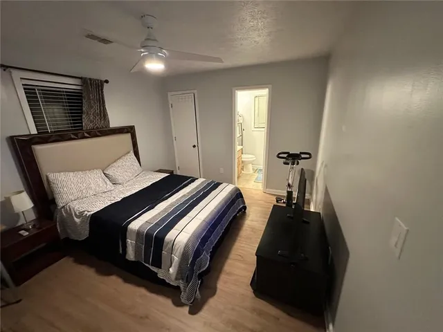 a bed room with a bed and a night stand