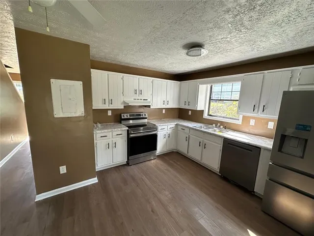 a kitchen with wooden cabinets and white appliances